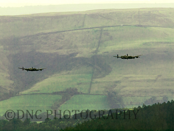 BBMF AVRO Lancaster (Mk I) PA474 City of Lincoln leads CWHM AVRO Lancaster (Mk X) FM213 VERA over Derwent Dam