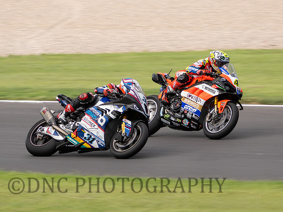 Garrett Gerloff Bonovo Action BMW M 1000 RR passing Axel Bassani Motocorsa Racing Ducati Panigale V4R