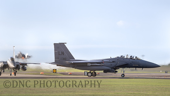 F-15E Strike Eagle LN AF 91-310 as F-35A 5614 takes off